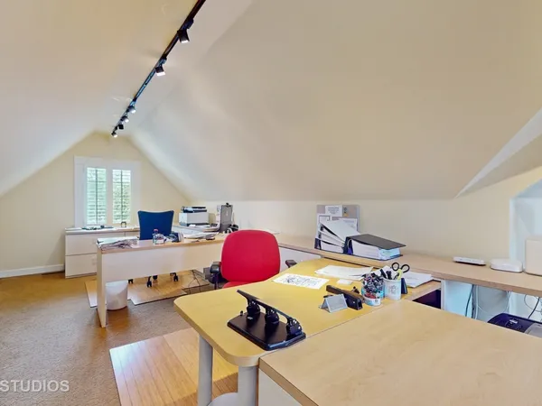 a bedroom with furniture and a wooden floor