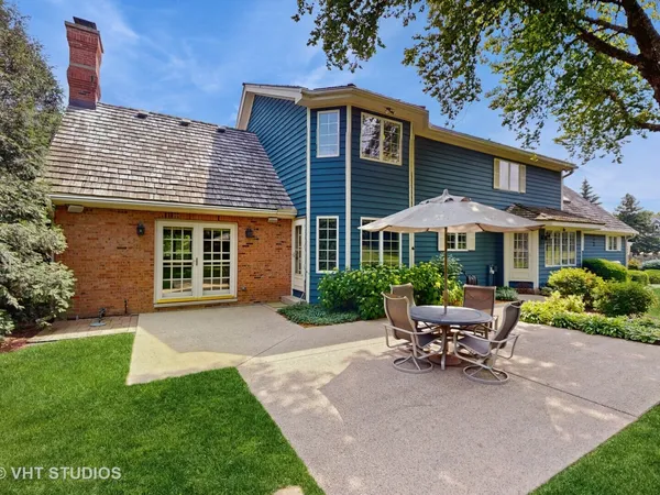 a view of a house with a yard and sitting area