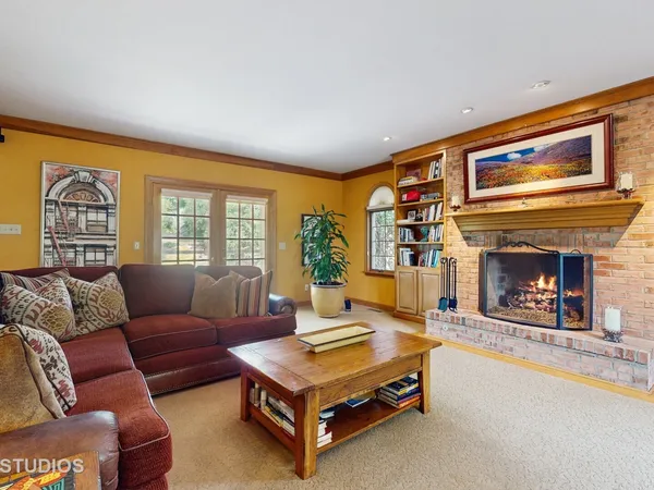 a living room with furniture a flat screen tv and a fireplace