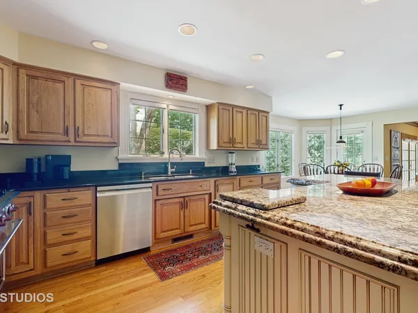 a kitchen with stainless steel appliances granite countertop a sink and a stove