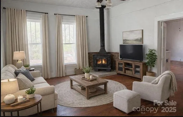 a living room with furniture a fireplace and a flat screen tv