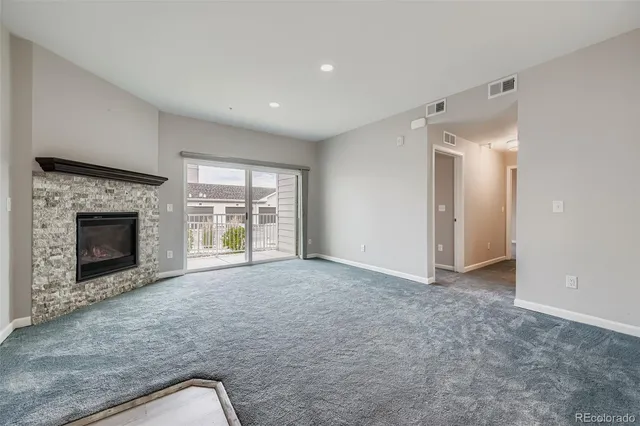 a view of empty room with a fireplace