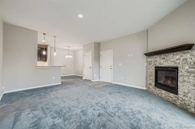 a view of empty room with a fireplace and window