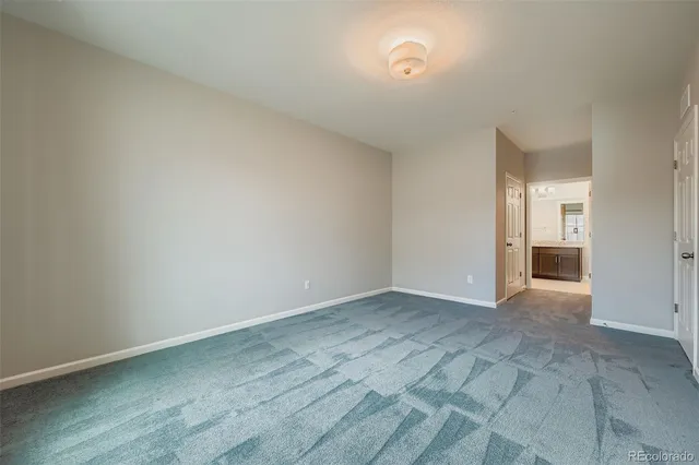 a view of an empty room and closet area