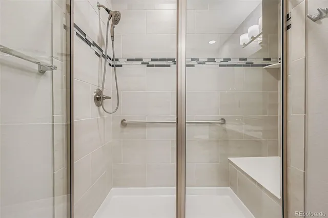 a bathroom with a glass shower door