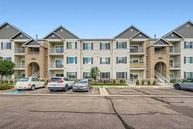 a car parked in front of a white building