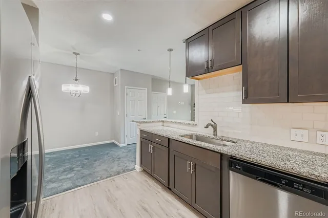 a kitchen with a sink and refrigerator