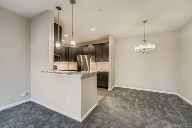 a kitchen with kitchen island a counter top space appliances and cabinets