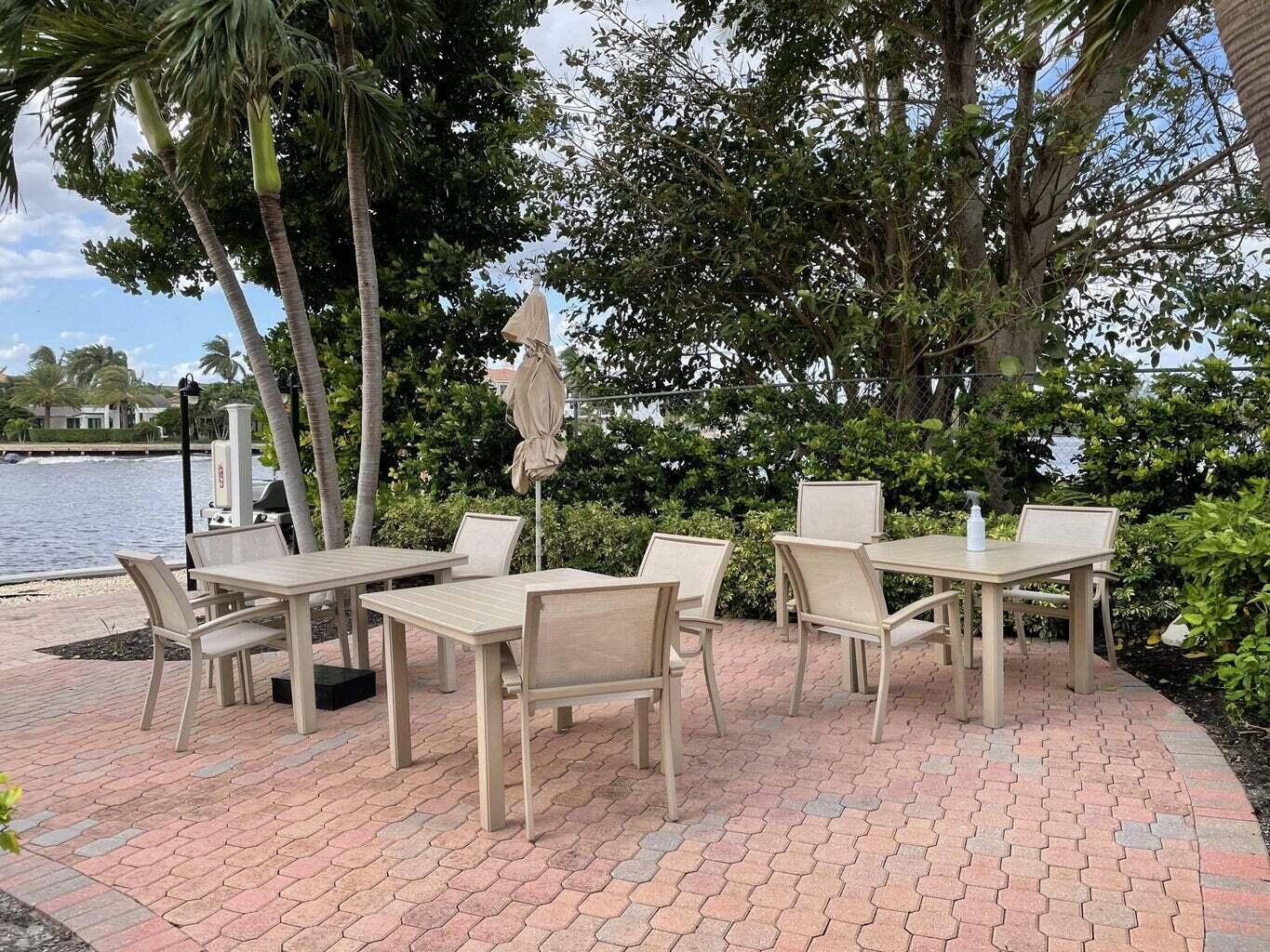 2707 North Ocean Boulevard, Unit D205 Boca Raton, FL 33431 - Photo 35 of 51 a view of a patio with table and chairs and couches