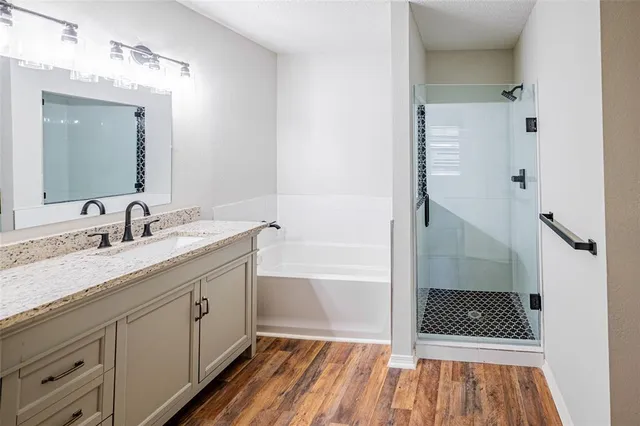 a bathroom with a sink a mirror and shower