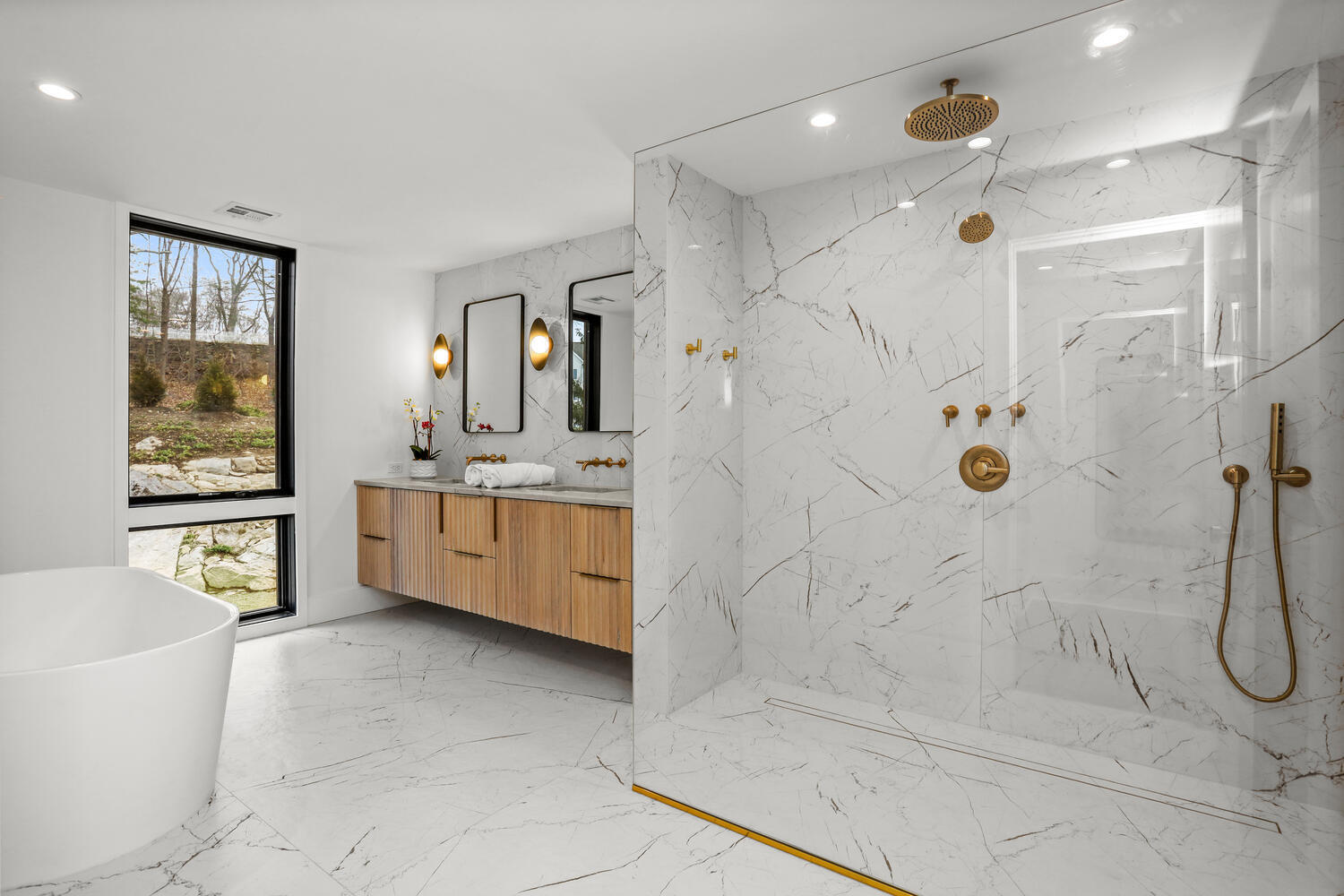 38 Goodwives River Road Darien, CT 06820 - Photo 29 of 58 a bathroom with a double vanity sink a mirror a bathtub and next to a window