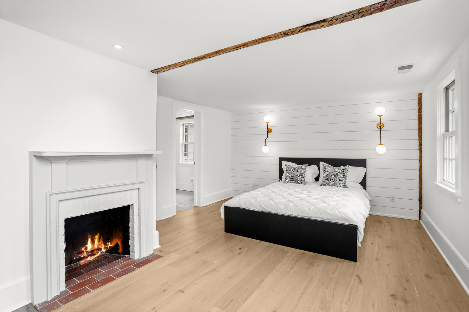 38 Goodwives River Road Darien, CT 06820 - Photo 33 of 58 a bedroom with a bed and a fireplace