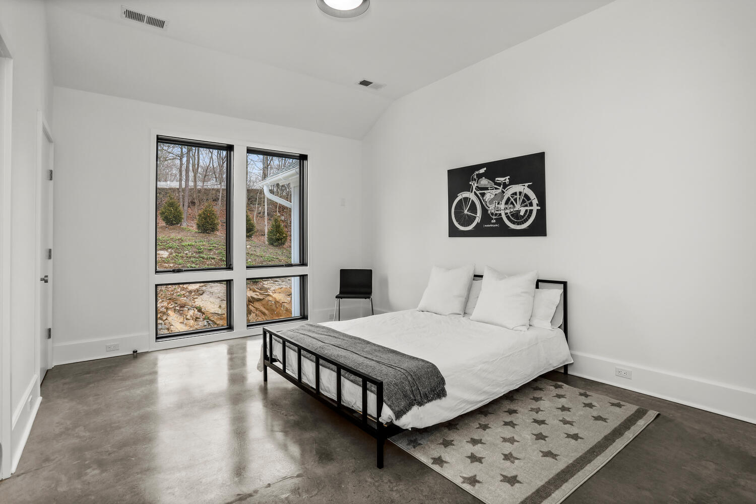 38 Goodwives River Road Darien, CT 06820 - Photo 43 of 58 a bedroom with a bed and a large window with outer view