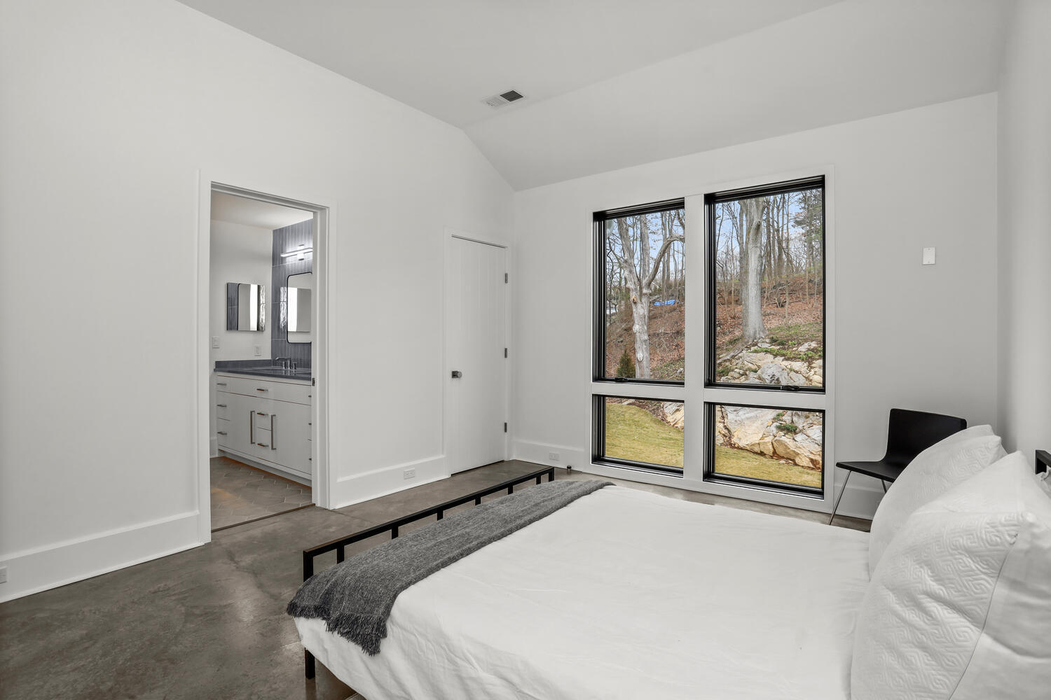 38 Goodwives River Road Darien, CT 06820 - Photo 44 of 58 a bedroom with a bed and a large window