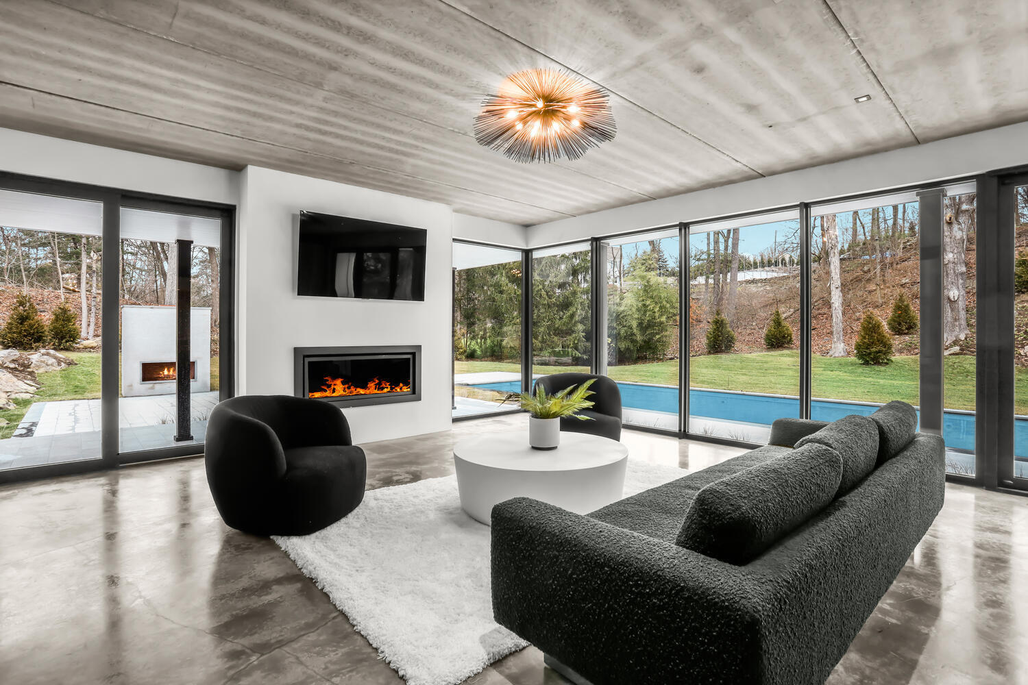 38 Goodwives River Road Darien, CT 06820 - Photo 7 of 58 a living room with furniture a fireplace and a large window