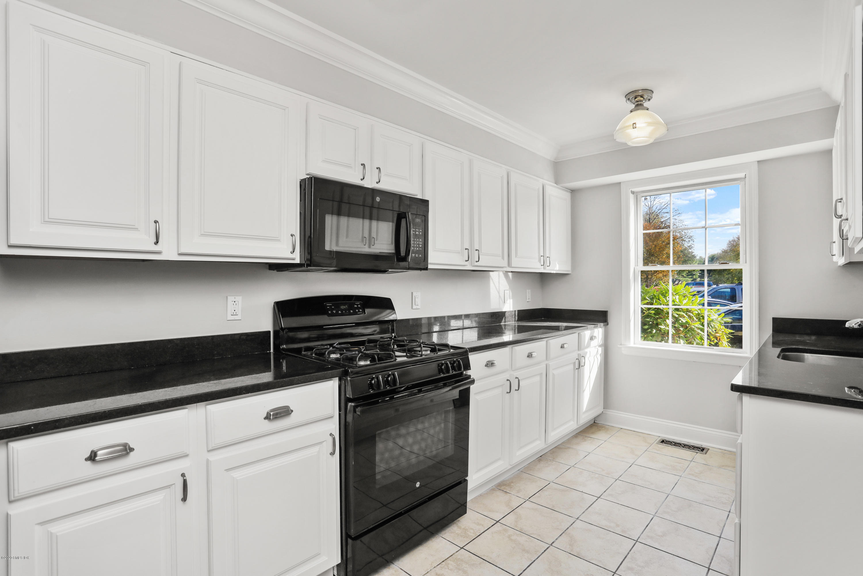 33 Talbot Lane, Unit 20 Greenwich, CT 06830 - Photo 6 of 20 a kitchen with granite countertop white cabinets and appliances
