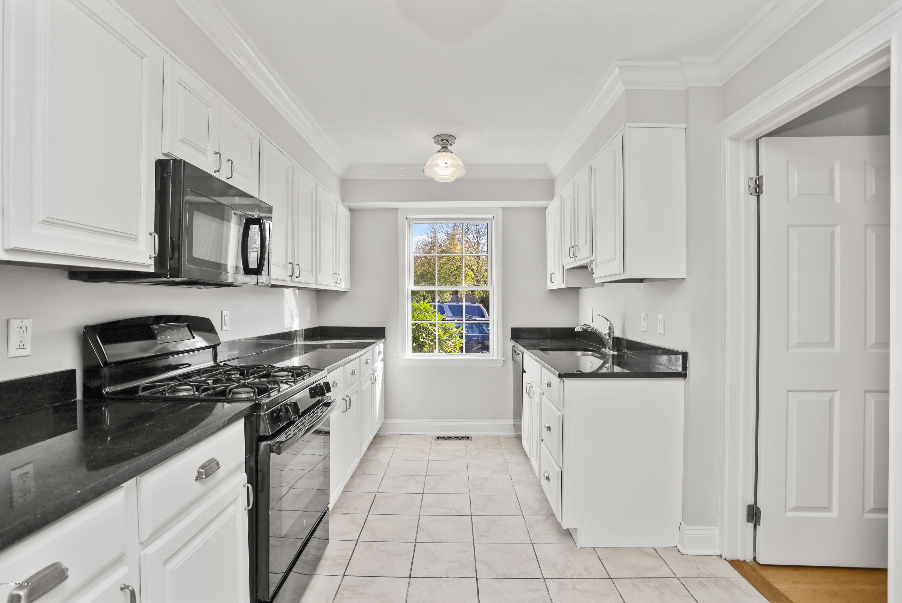 33 Talbot Lane, Unit 20 Greenwich, CT 06830 - Photo 7 of 20 a kitchen with granite countertop a stove sink and cabinets