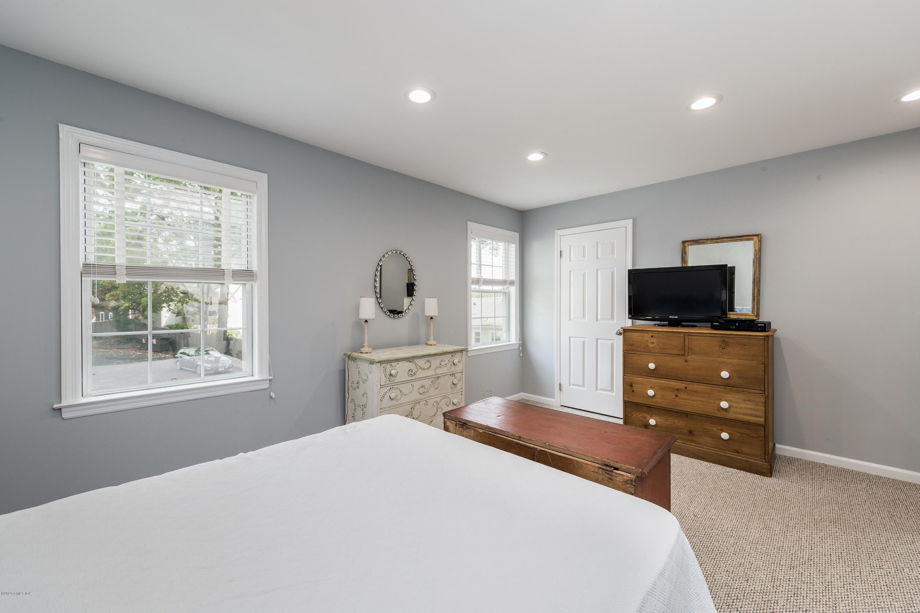 33 Talbot Lane, Unit 20 Greenwich, CT 06830 - Photo 10 of 20 a bedroom with a bed and a flat screen tv