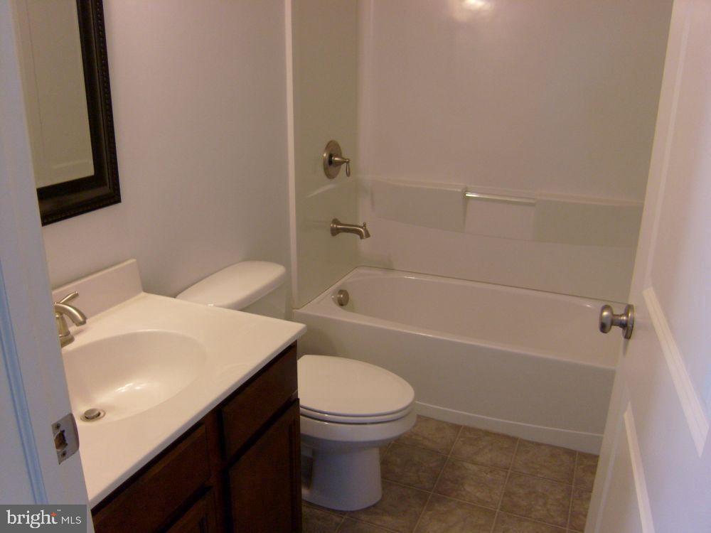 3784 William Daves Road, Unit 12 Doylestown, PA 18902 - Photo 15 of 19 a bathroom with a sink a toilet and a bathtub