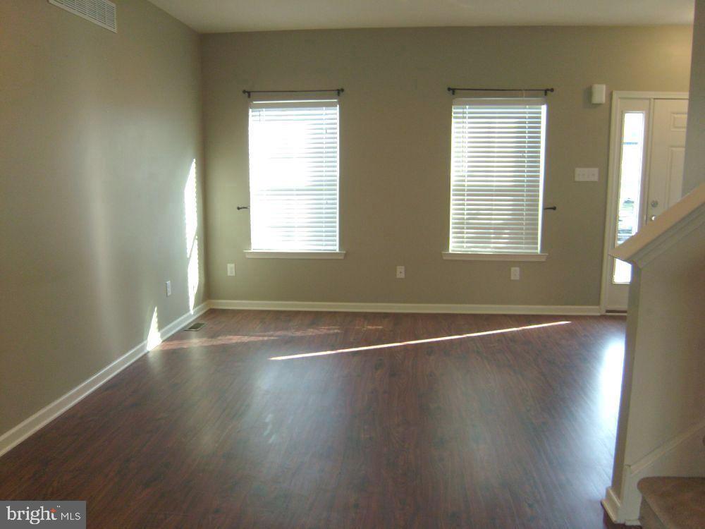 3784 William Daves Road, Unit 12 Doylestown, PA 18902 - Photo 5 of 19 an empty room with wooden floor and windows