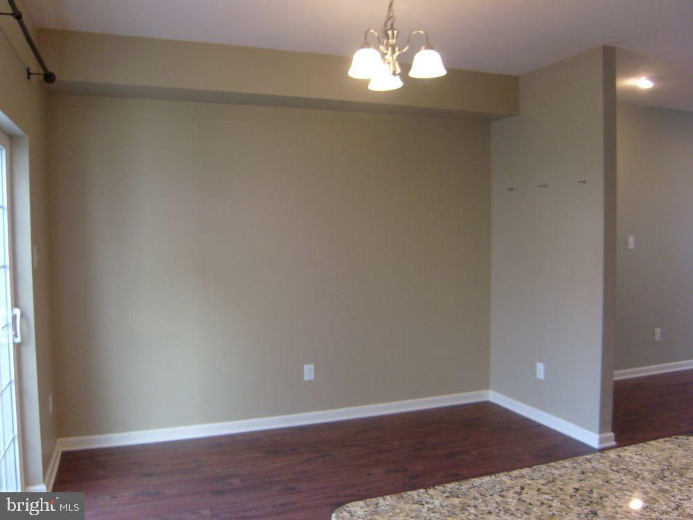 3784 William Daves Road, Unit 12 Doylestown, PA 18902 - Photo 8 of 19 a view of empty room with wooden floor and chandelier