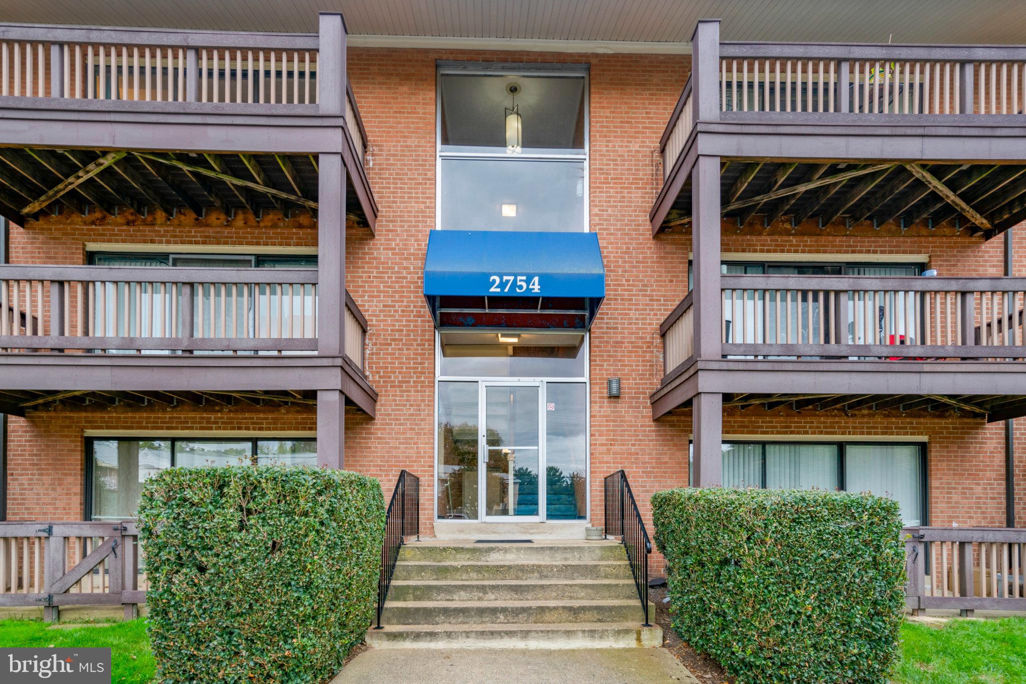 a view of front door of house with stairs