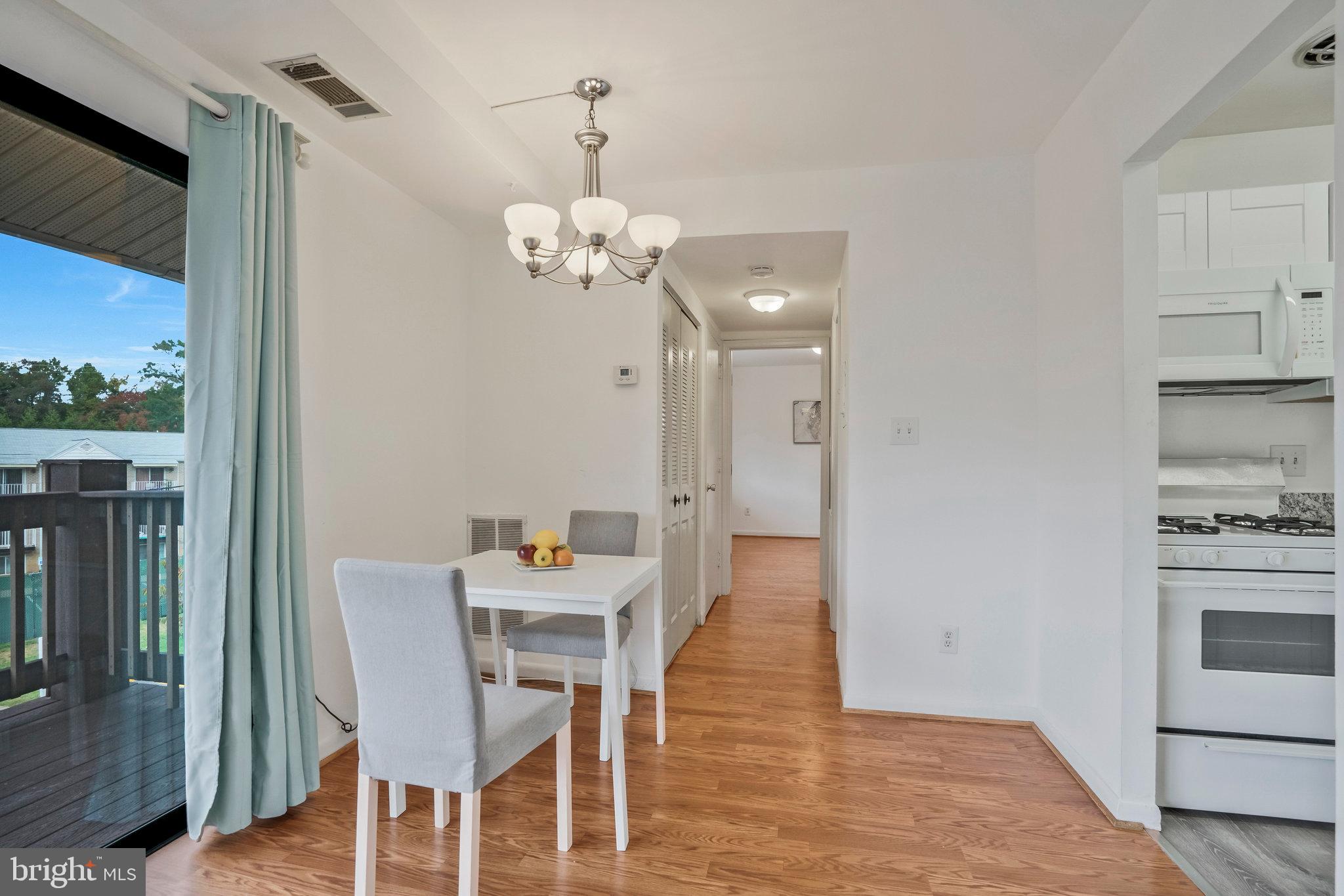 2754 Hollywood Road, Unit 301 Falls Church, VA 22043 - Photo 23 of 35 a view of a dining room with furniture wooden floor and a chandelier