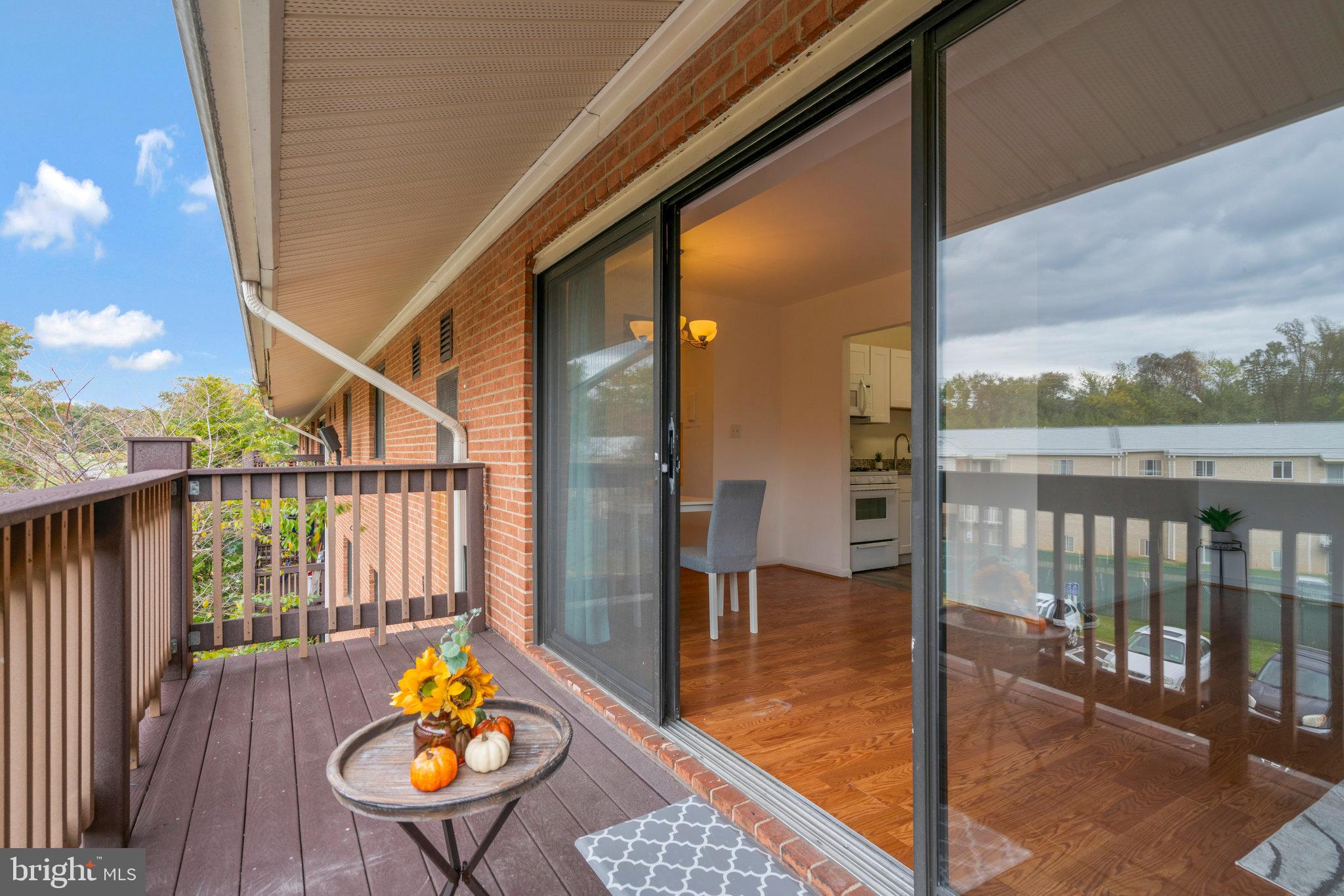 2754 Hollywood Road, Unit 301 Falls Church, VA 22043 - Photo 24 of 35 a view of a balcony dining table and wooden floor
