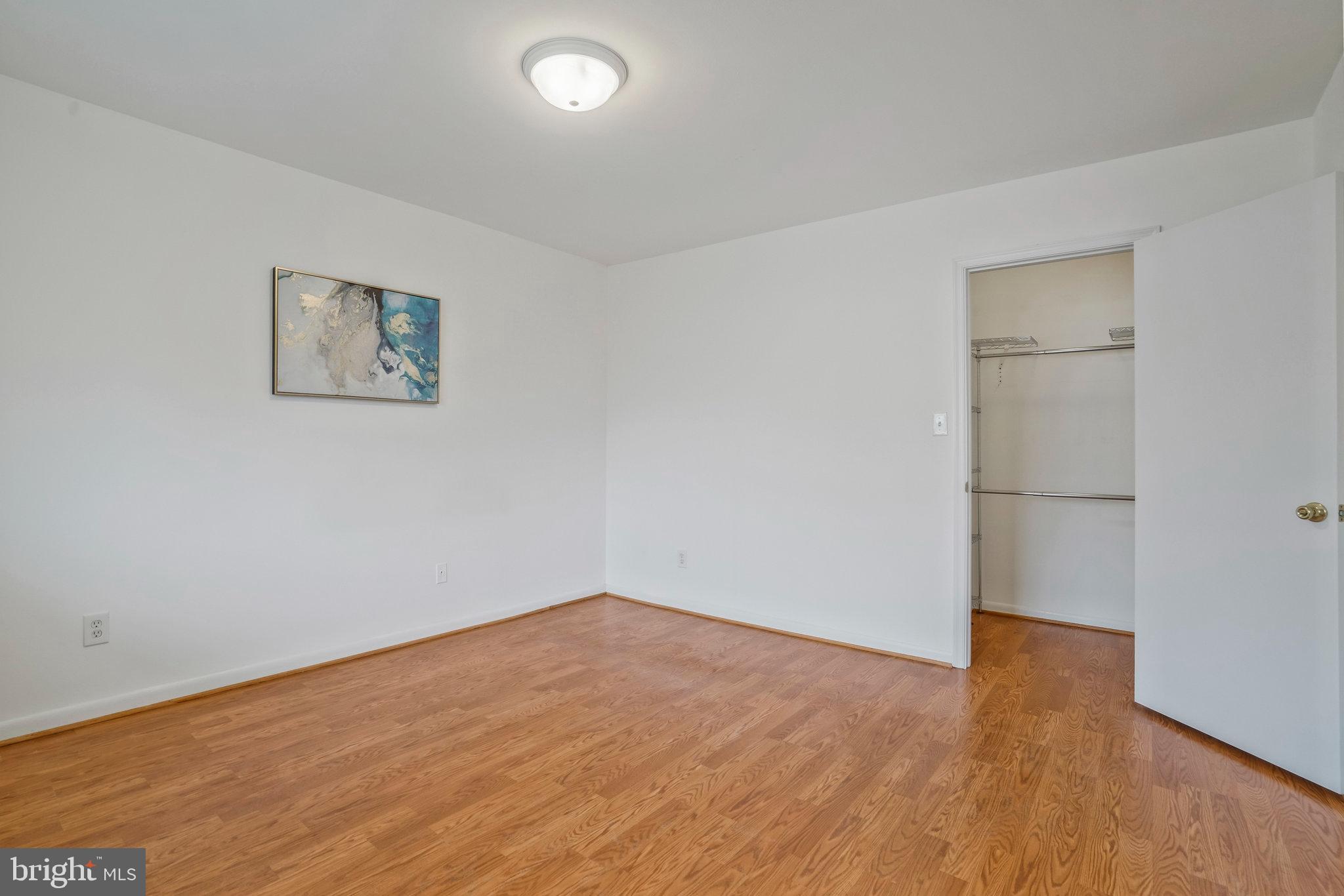 2754 Hollywood Road, Unit 301 Falls Church, VA 22043 - Photo 10 of 35 an empty room with wooden floor and windows