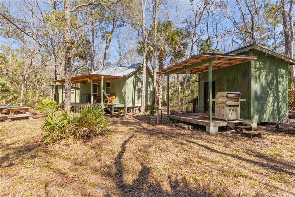 86 Southwest Turtle Pass Road Chiefland, FL 32626 - Photo 20 of 37 a view of a house with backyard and sitting area