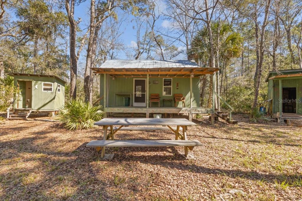 86 Southwest Turtle Pass Road Chiefland, FL 32626 - Photo 3 of 37 a view of a house with backyard porch and sitting area