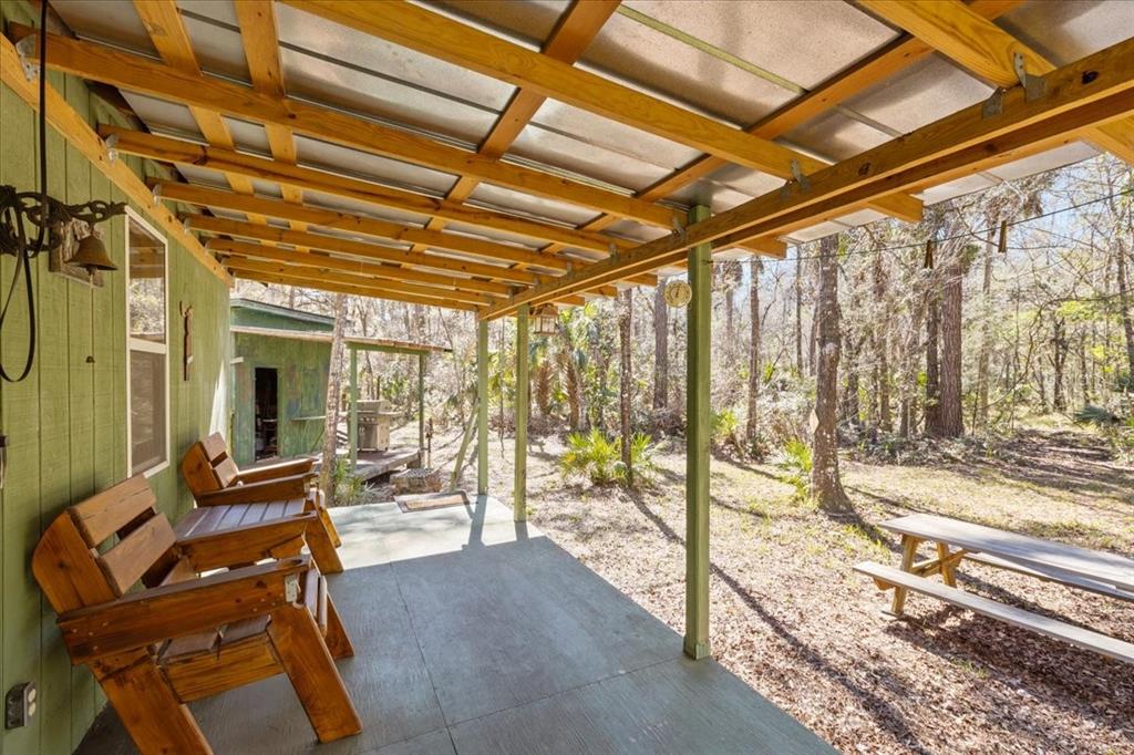 86 Southwest Turtle Pass Road Chiefland, FL 32626 - Photo 4 of 37 a view of a living room and floor to ceiling window