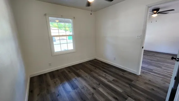 a view of an empty room and wooden floor