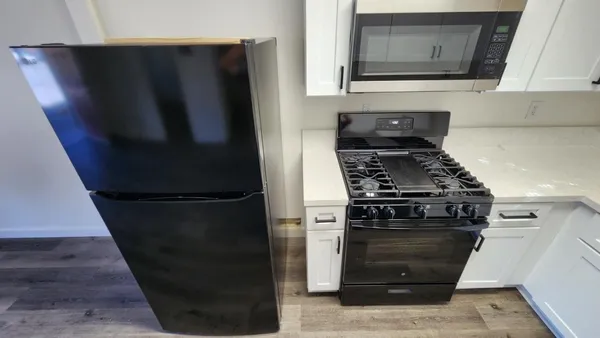a kitchen with a stove and a refrigerator