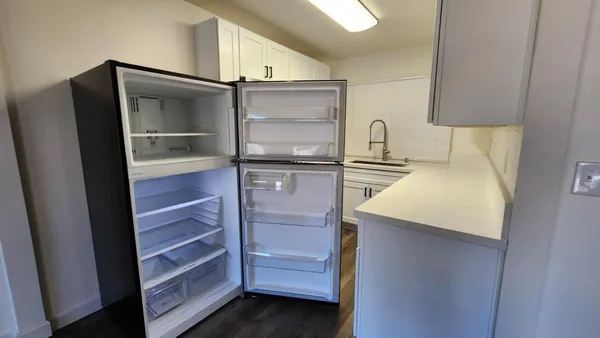 a kitchen with a refrigerator and cabinets