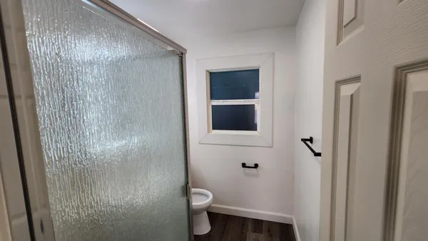 a bathroom with a toilet and a shower