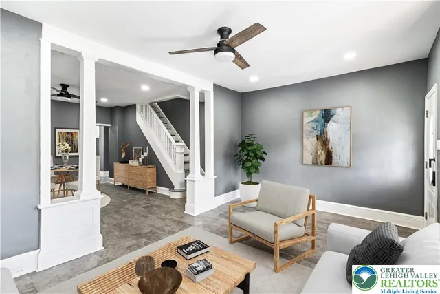 a living room with furniture and stairs