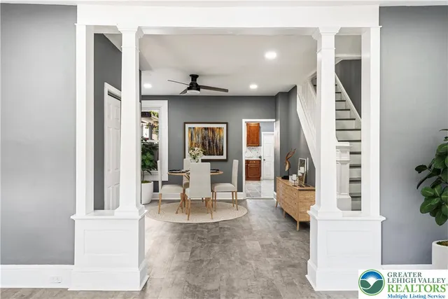 a living room with furniture and a potted plant