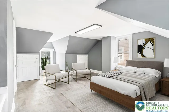 a spacious bedroom with a bed and a painting on the wall