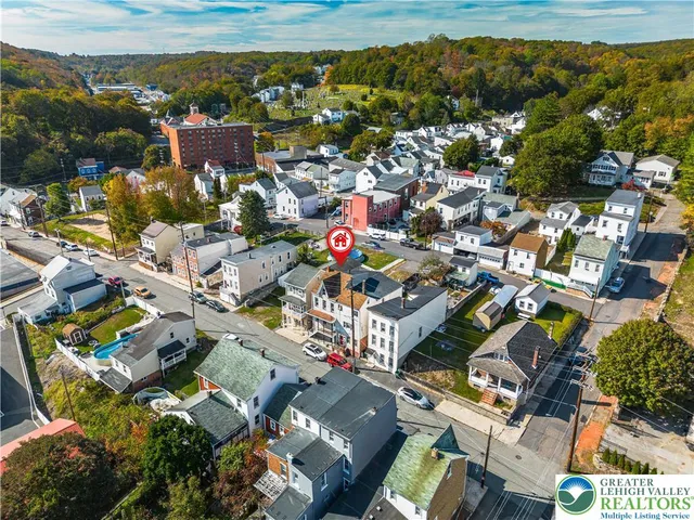 an aerial view of residential houses with outdoor space