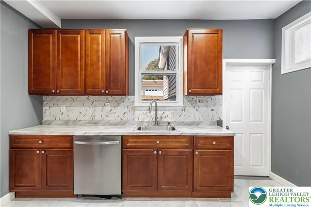 a kitchen with stainless steel appliances granite countertop a sink and a cabinets