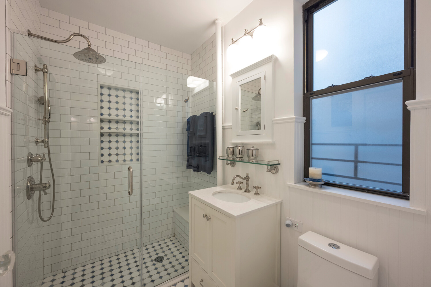 124 East 84th Street, Unit 5D Manhattan, NY 10028 - Photo 4 of 10 a bathroom with a sink a toilet and shower