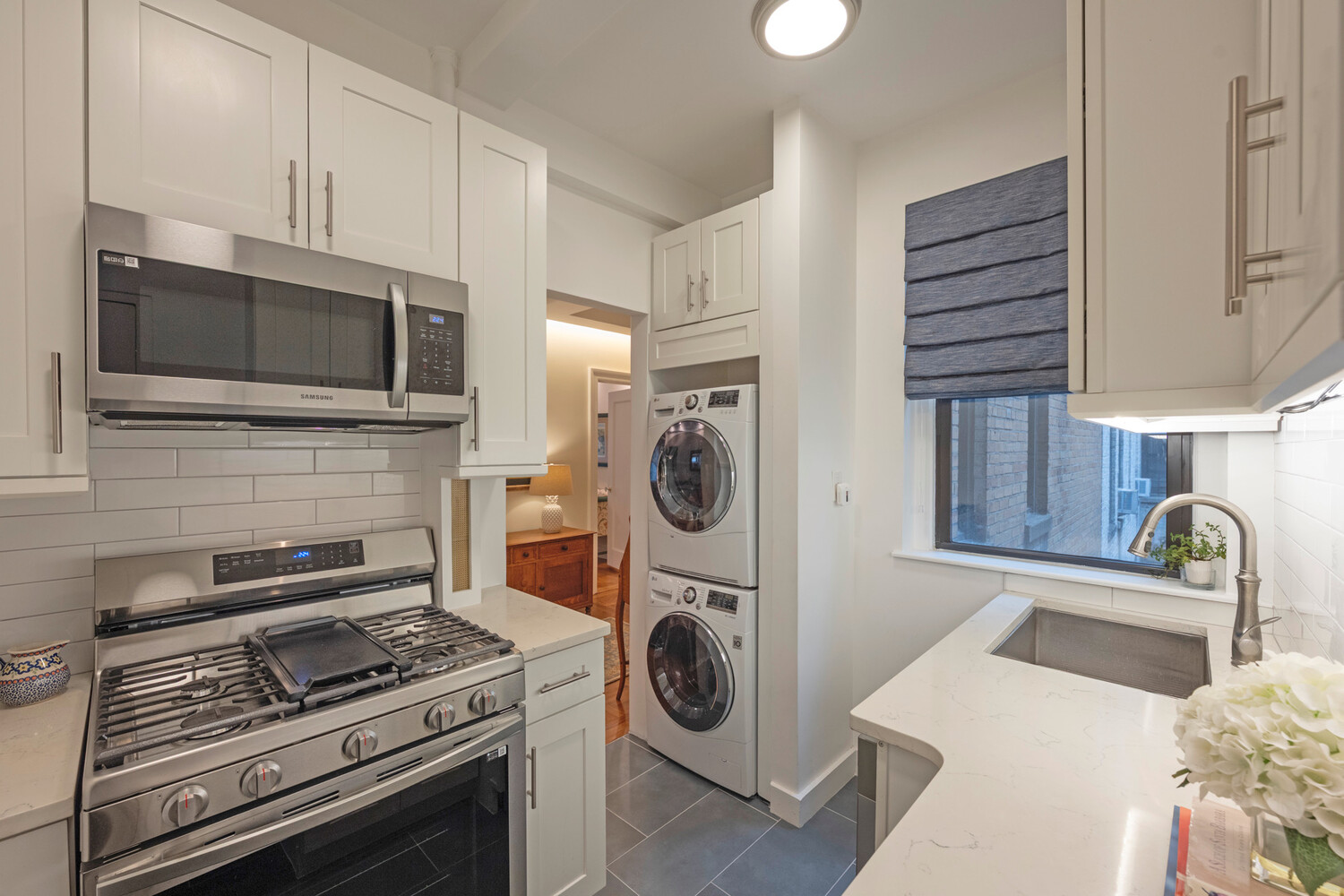 124 East 84th Street, Unit 5D Manhattan, NY 10028 - Photo 5 of 10 a kitchen with a stove and a sink