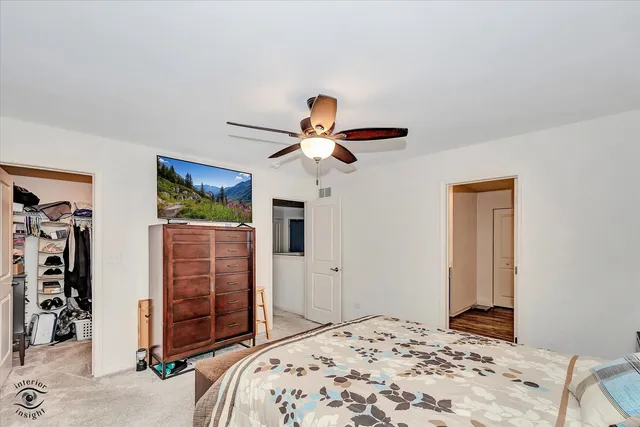 a bedroom with a bed and a chandelier