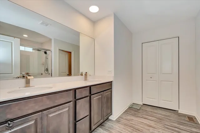 a bathroom with a double vanity sink and a mirror