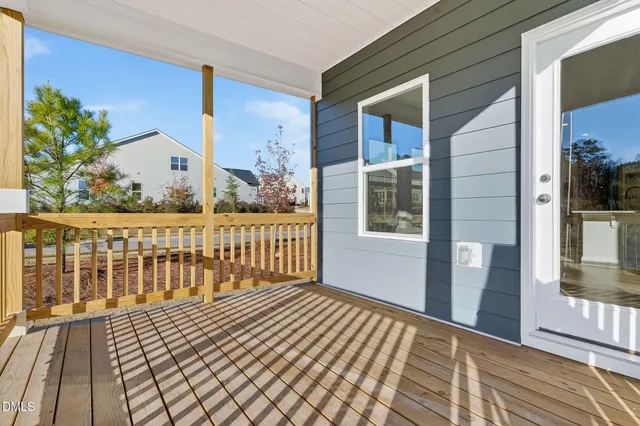 a view of a balcony with wooden floor