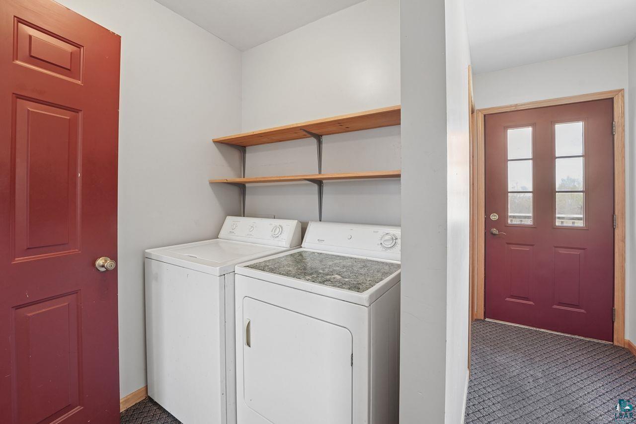 2909 Golf Course Road Ashland, WI 54806 - Photo 22 of 34 Dedicated laundry area featuring white appliances and two wood-finish floating shelves