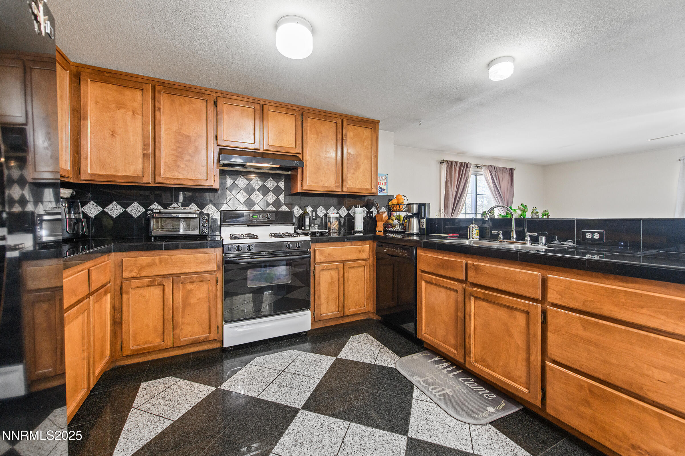 532 Yellow Jacket Road Dayton, NV 89403 - Photo 11 of 18 a kitchen with stainless steel appliances granite countertop a stove a sink and a microwave