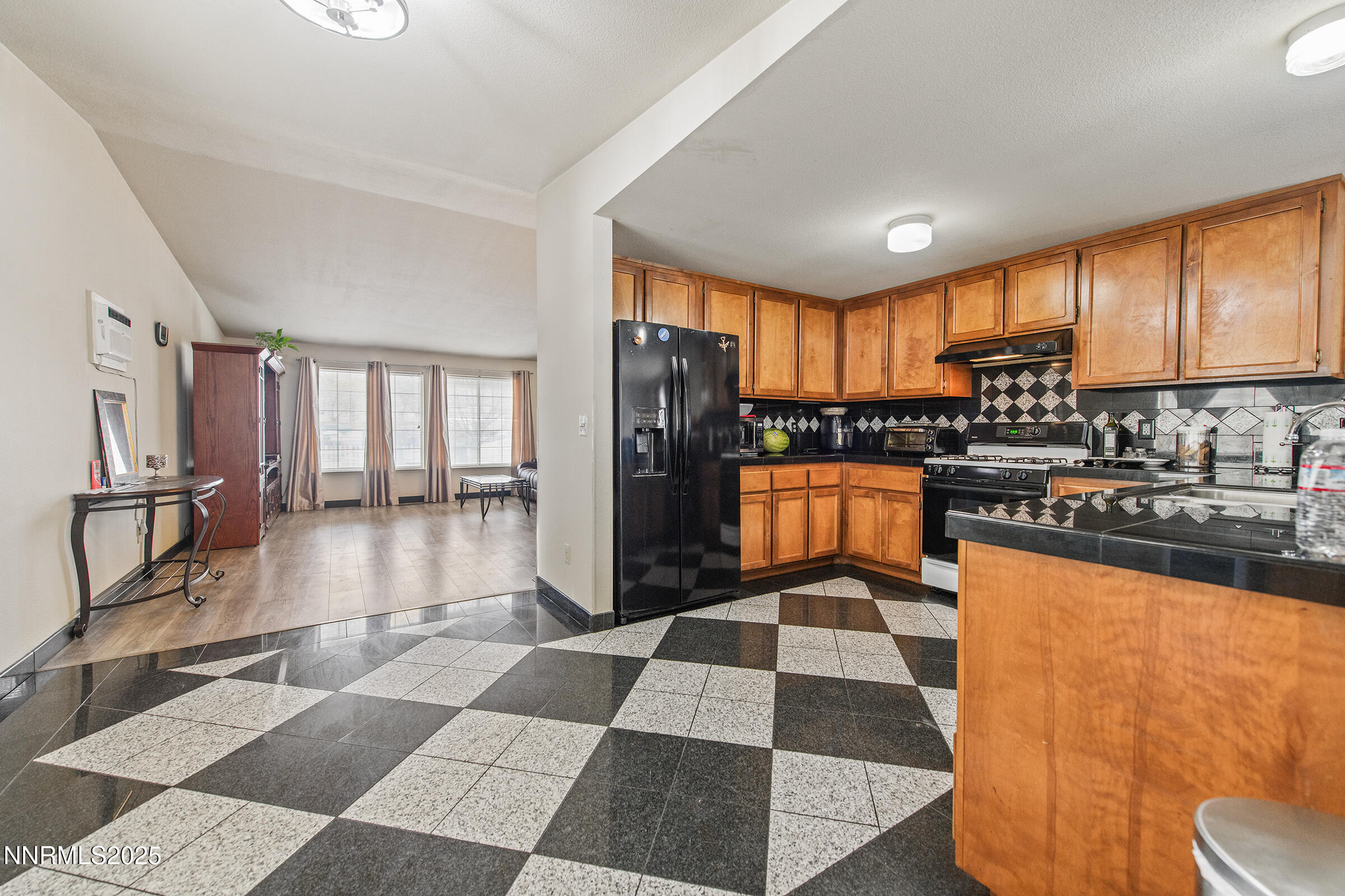 532 Yellow Jacket Road Dayton, NV 89403 - Photo 15 of 18 a kitchen with granite countertop stainless steel appliances a sink a counter top space cabinets and a view of living room