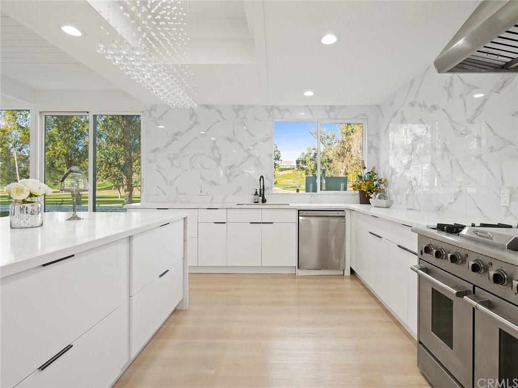 5100 Queen Street Riverside, CA 92506 - Photo 17 of 75 a kitchen with granite countertop a sink stainless steel appliances and cabinets